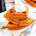 A close up of pumpkin spice waffles stacked on each other.