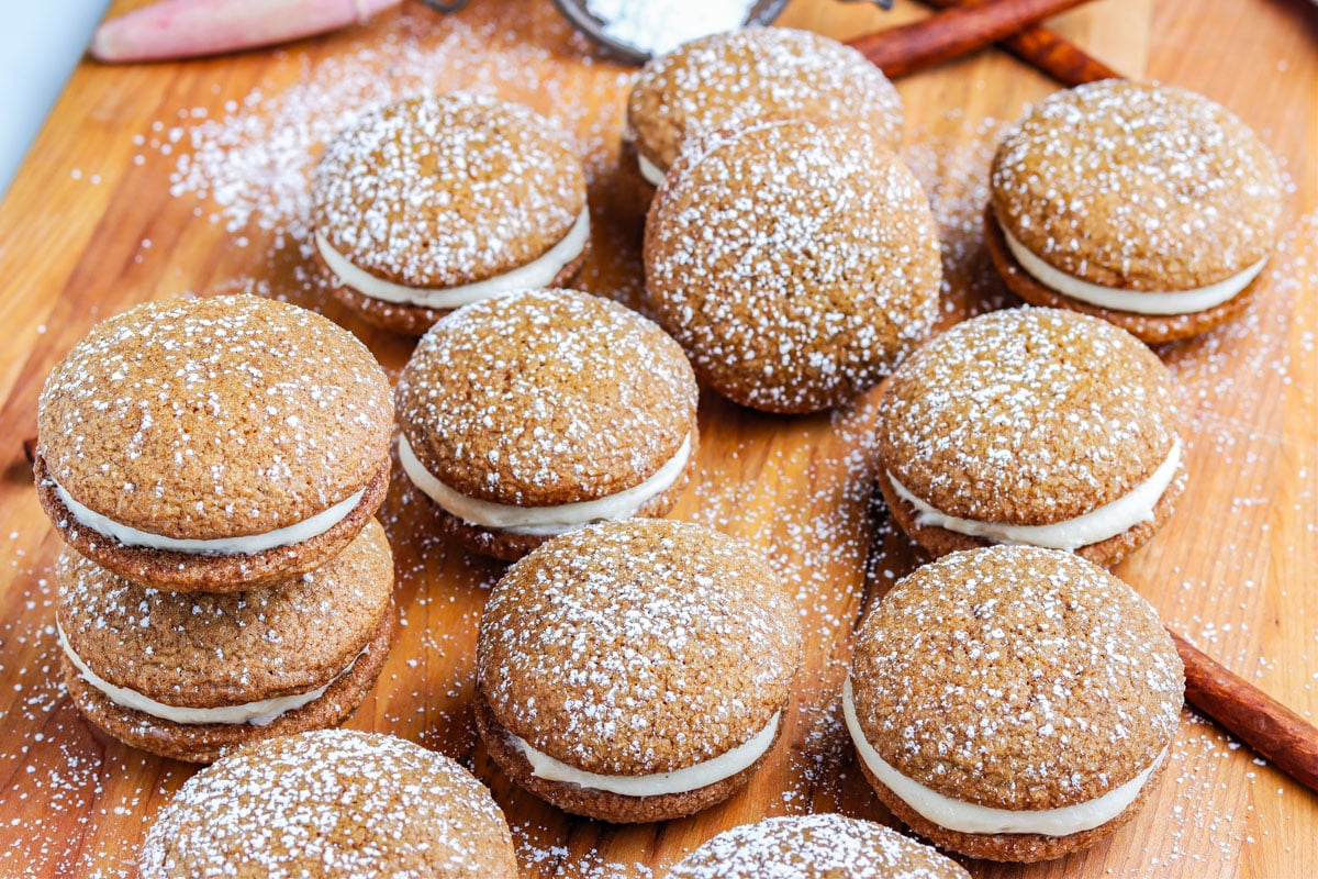The finished Gingerbread Whoopie Pies recipe on a wooden serving board.