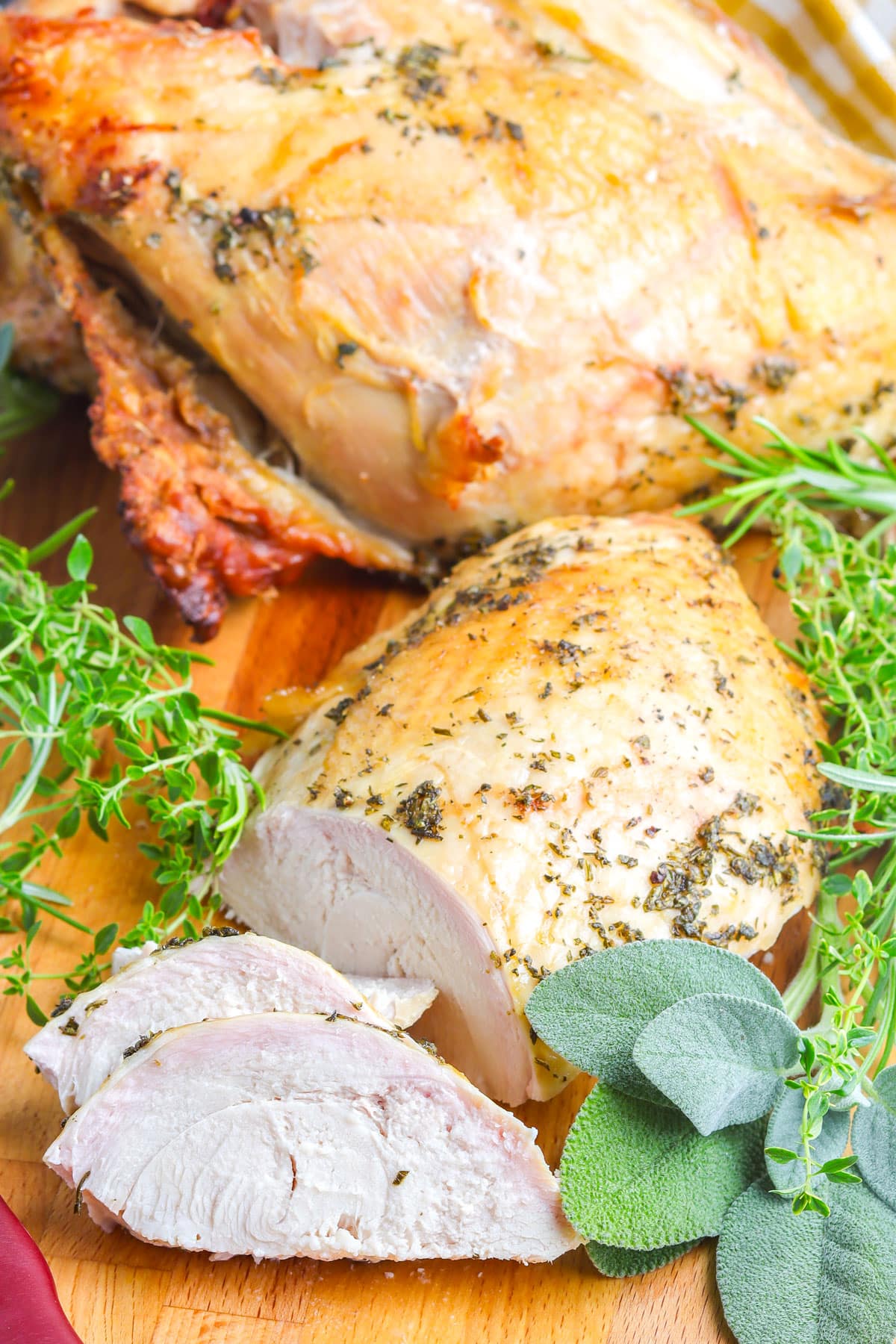 The finished Grilled Turkey Breast recipe on a wooden cutting board.