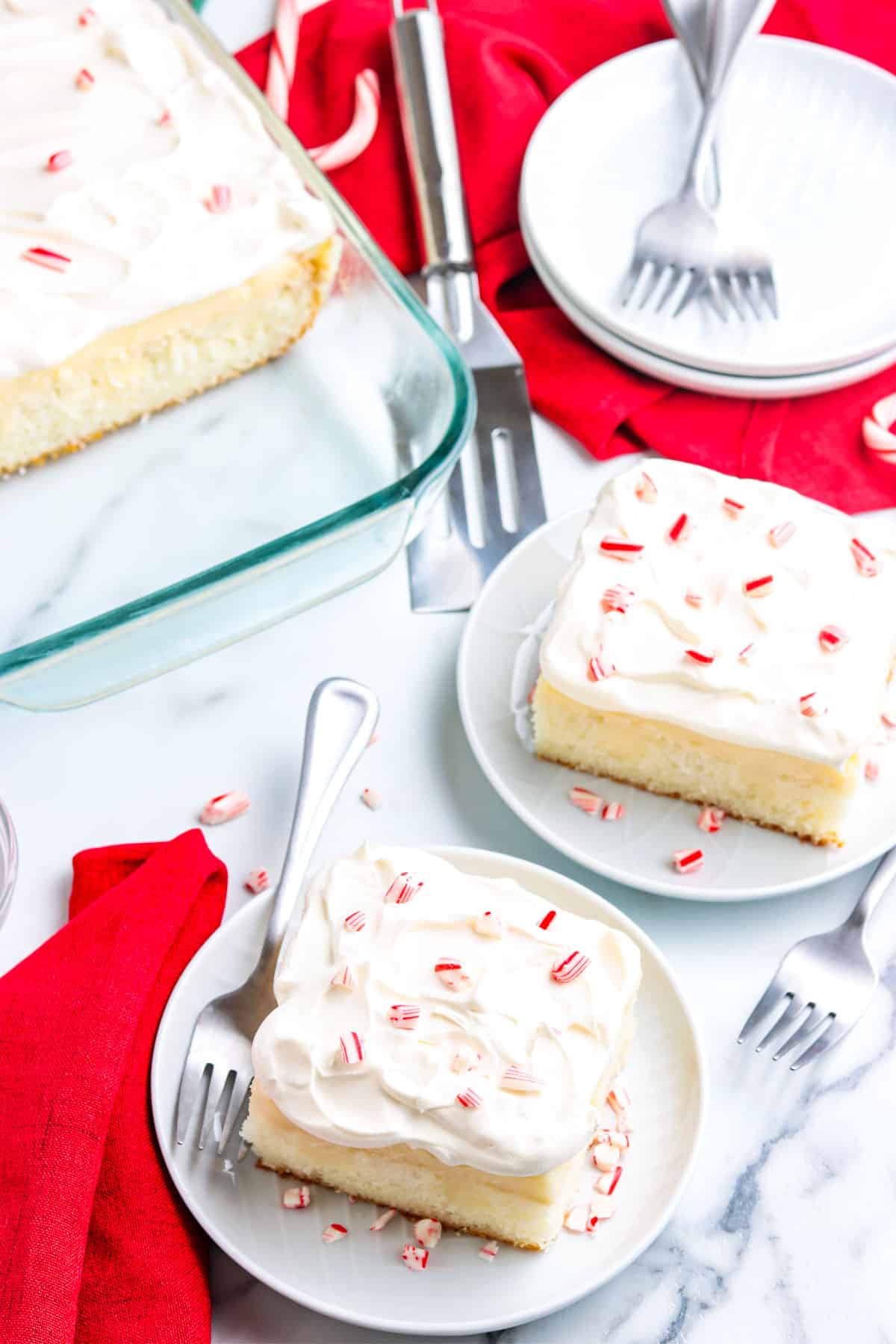 Two slices of cake on white plates.
