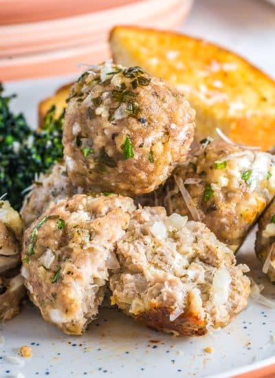 A close up of three Turkey Meatballs on a plate and one is cut in half.