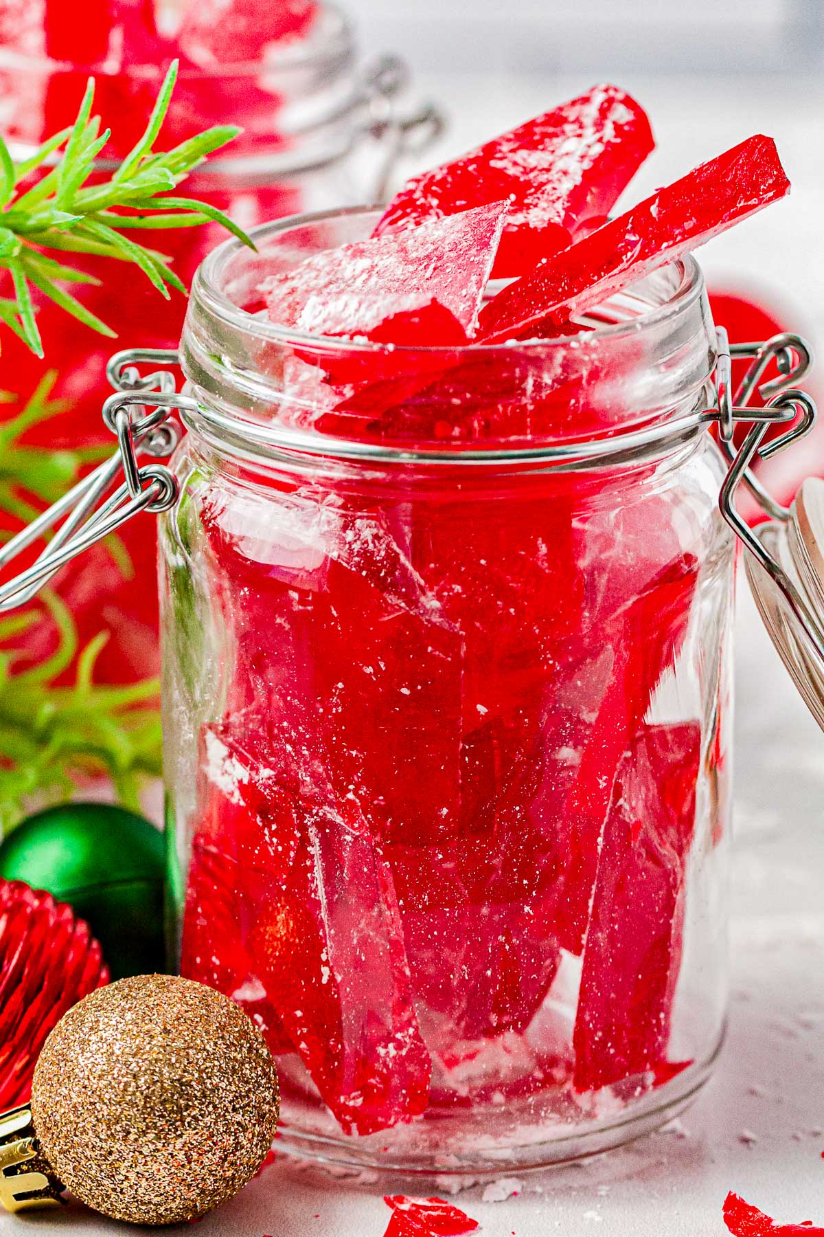 A glass jar filled with Cinnamon Candy.