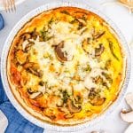 The finished mushroom spinach quiche on a tabletop.