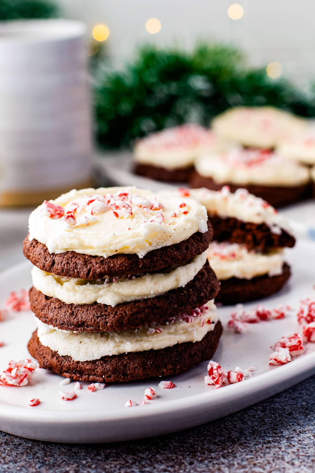 Three Peppermint Chocolate Cookies stacked on a white serving plate. 