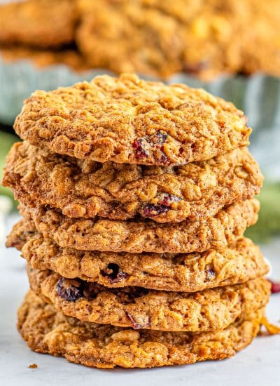 A stack of White Chocolate Cranberry Oatmeal Cookies on a counter.