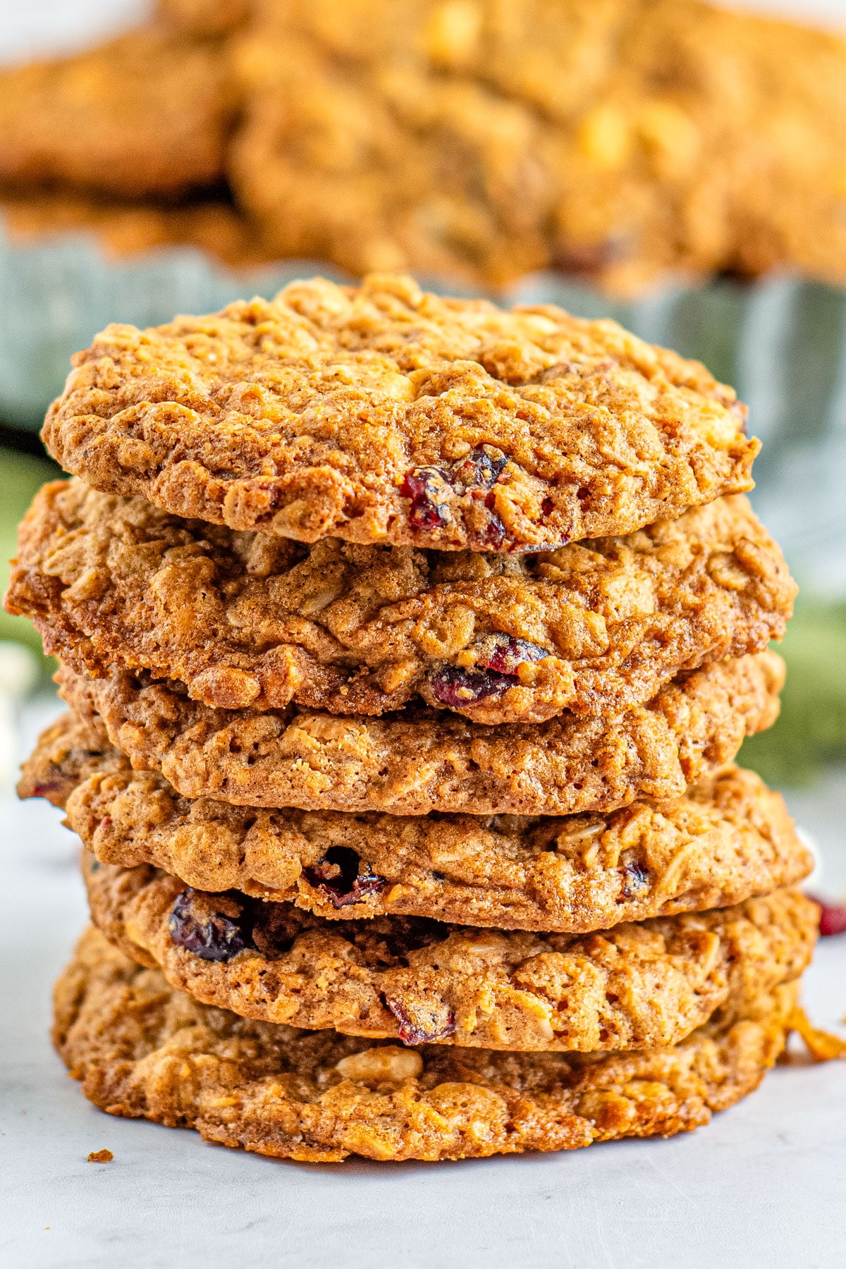 A stack of White Chocolate Cranberry Oatmeal Cookies on a counter. 