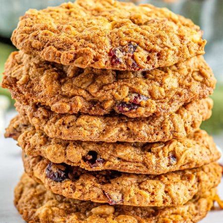 A close up picture of a stack fo these white chocolate oatmeal cranberry cookies.