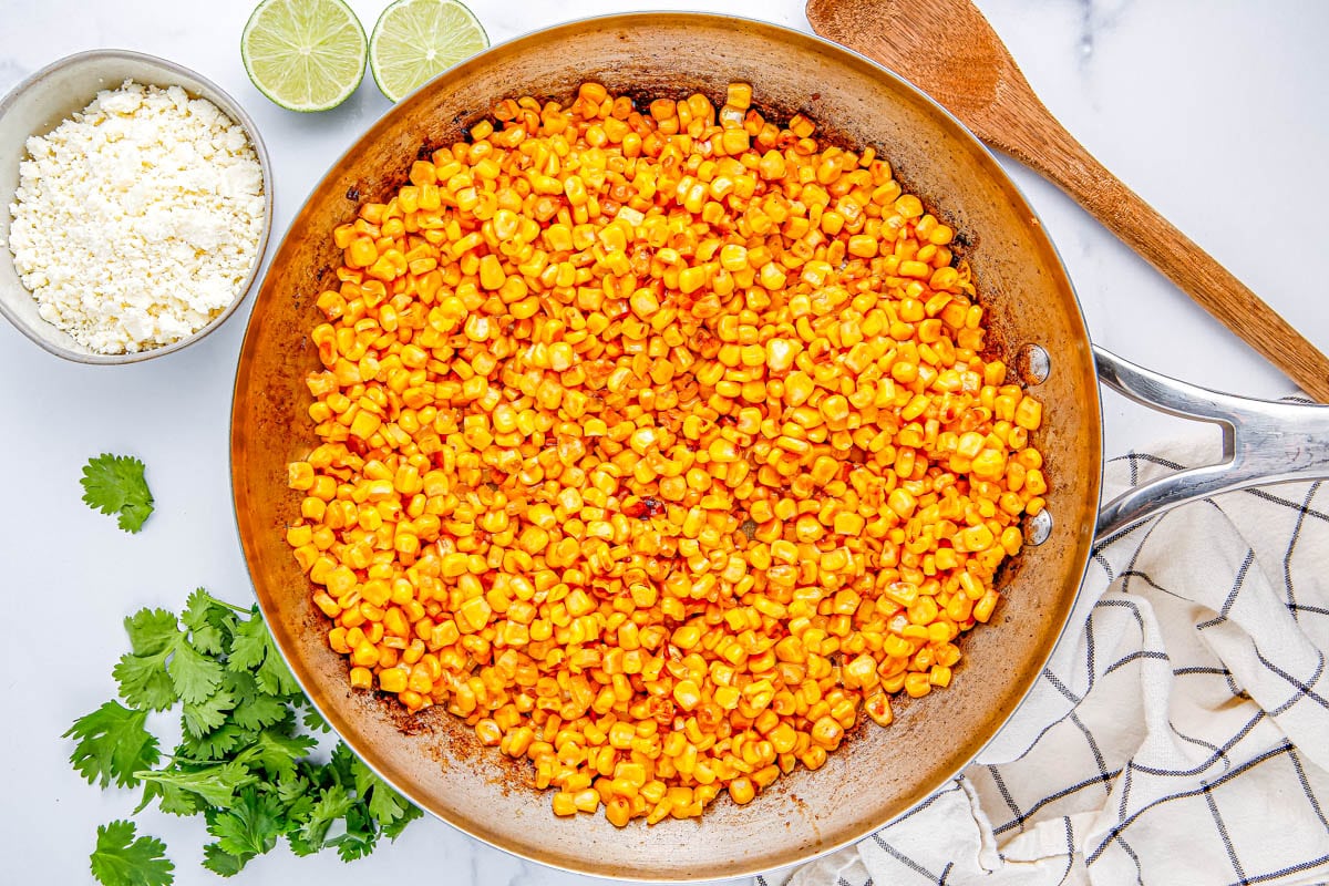 The corn sautéing on the stovetop.