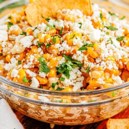 A close up of the finished Mexican Street Corn Dip in a glass bowl.