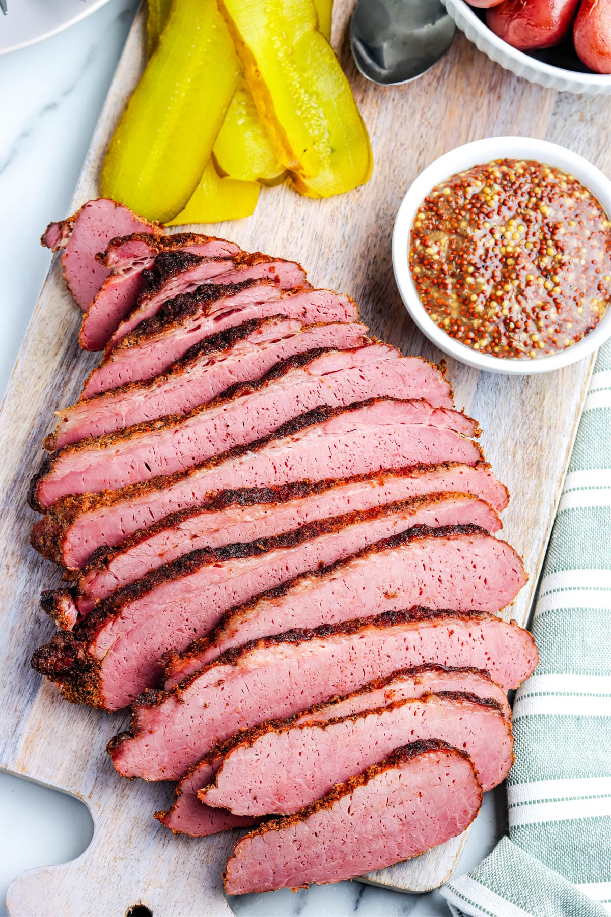The sliced Smoked Corned Beef on a cutting board. 