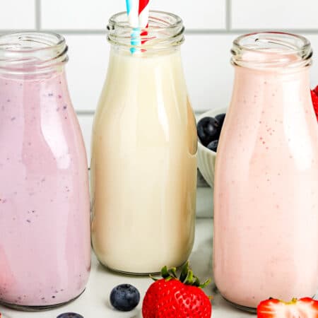The finished yogurt drink recipe in clear glass jars.