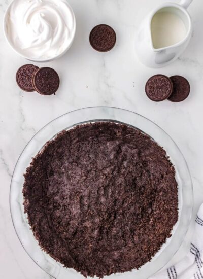 The finished Oreo Pie Crust in a clear Pyret pie plate.