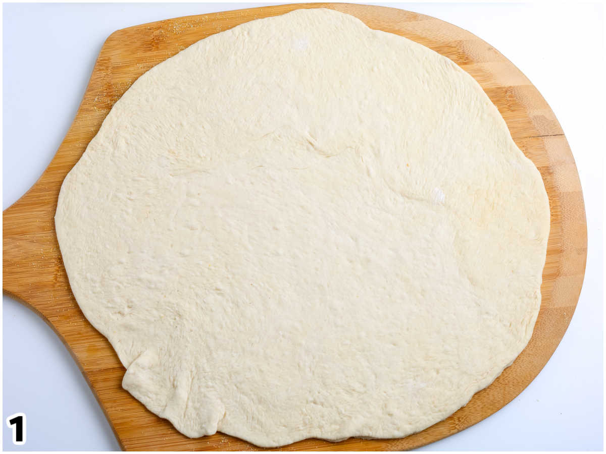 One of the dough rounds rolled out onto a pizza peel.