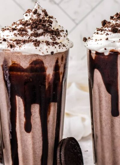 Two milkshakes in clear glasses.