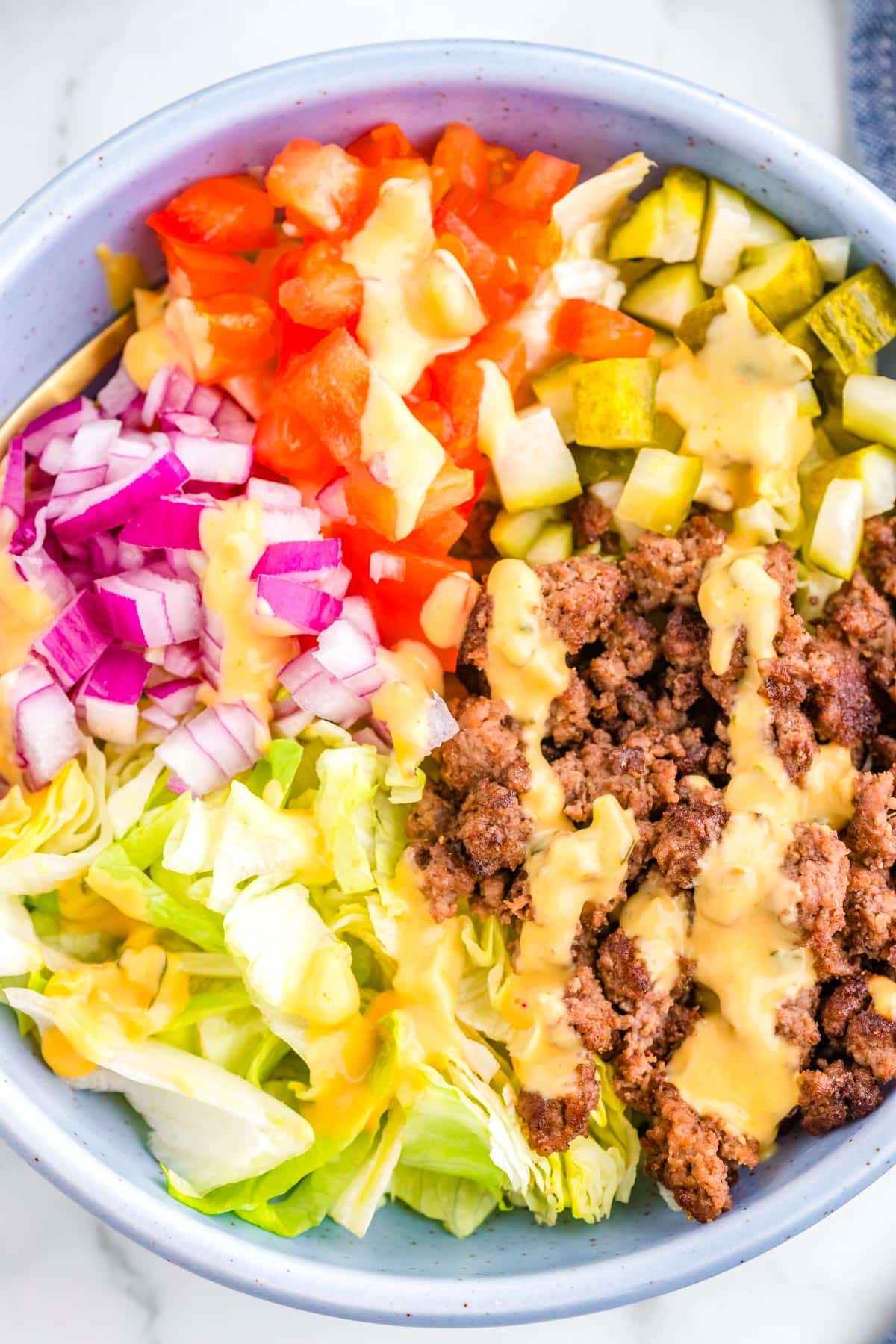 The assembled burger bowls in a white serving bowls.