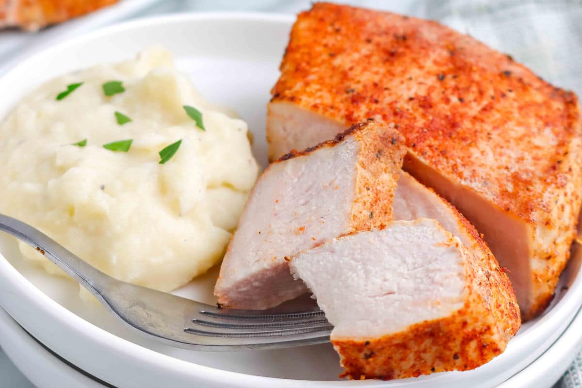 Cut up bonless pork chops on a plate.