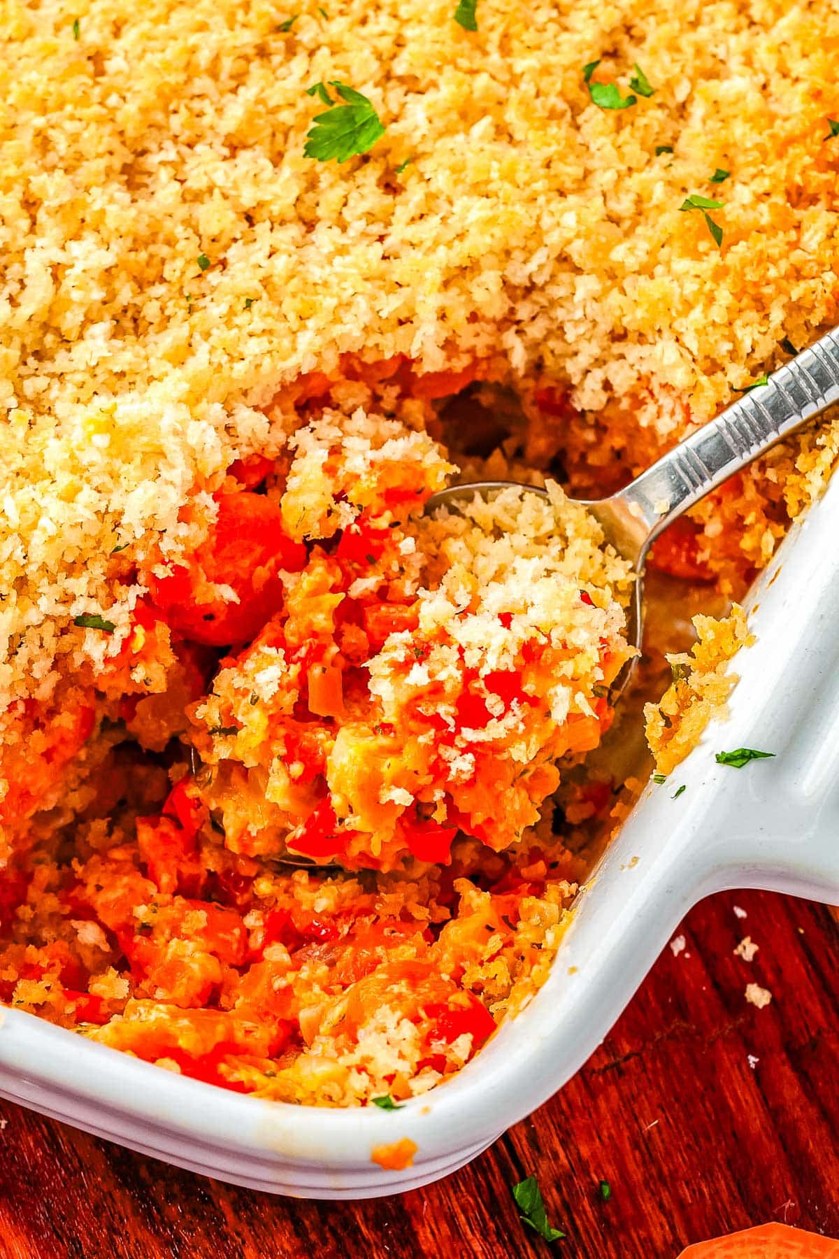 A spoon scooping up some of the finished casserole.