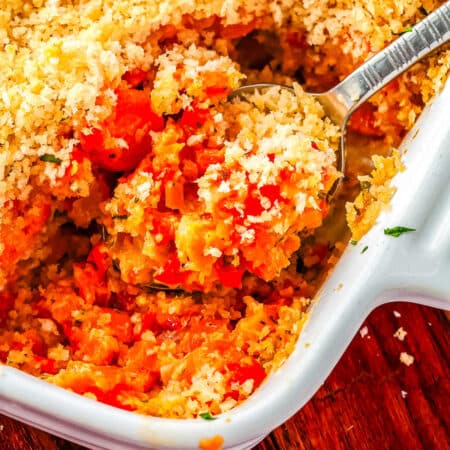A serving spoon scooping up some of the casserole.