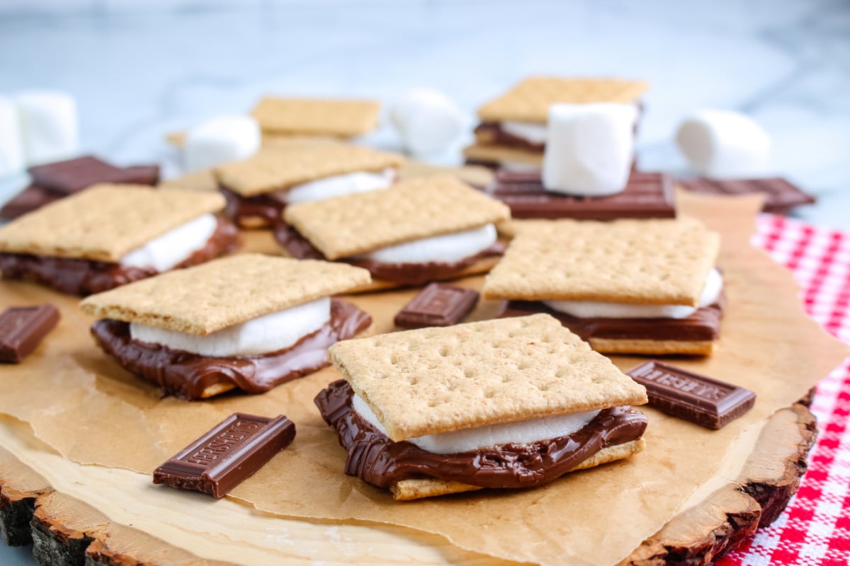a wooden platter of grilled s'mores