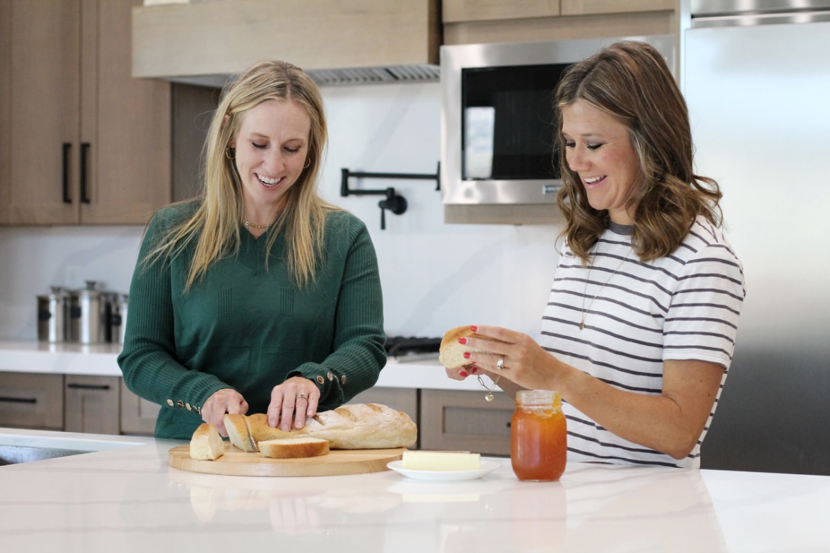 Owners of Easy Budget Recipes slicing bread in their kitchen