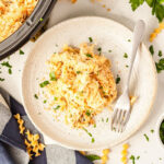 a plate of slow cooker chicken noodle casserole with the crockpot in the background