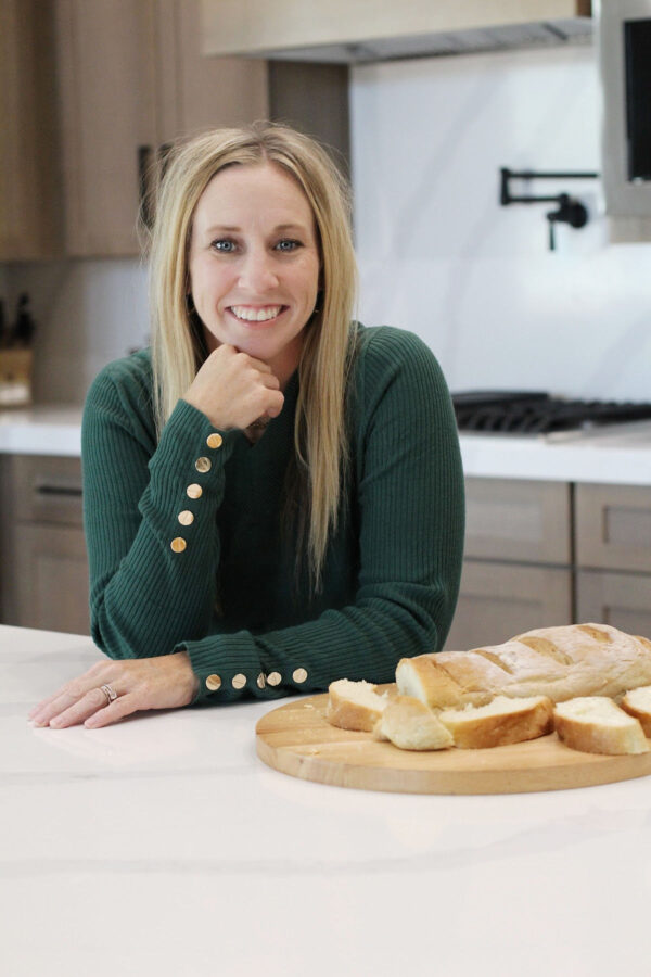 Jess Jankowski, in the kitchen with a loaf of French Bread
