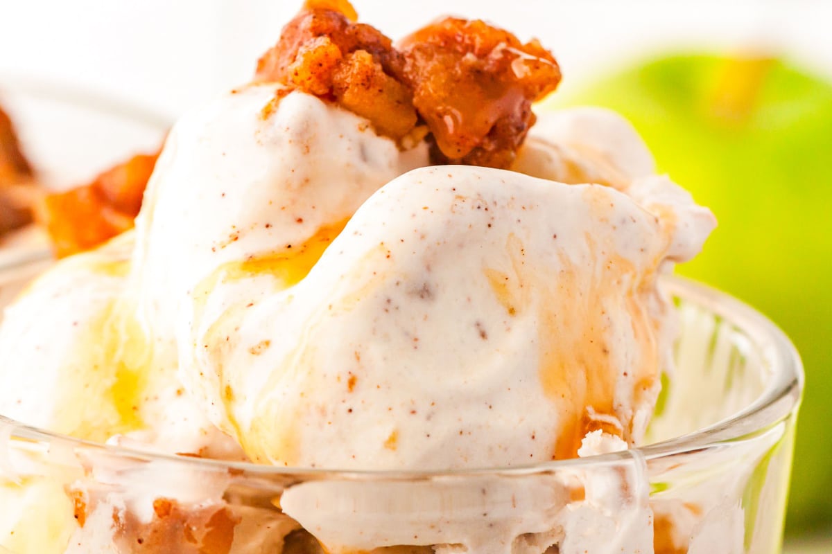 a close up of homemade apple pie ice cream in a glass serving dish